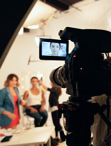 Video camera filming a studio interview behind the scenes