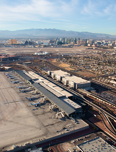 Aerial view of an airport terminal and city skyline