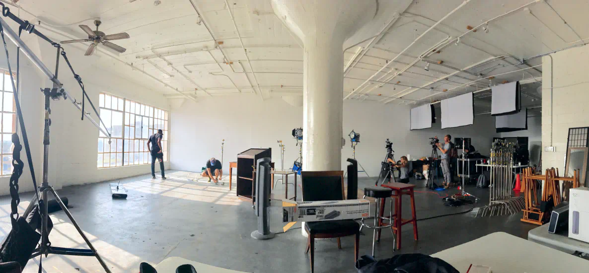 Video production studio with crew lighting a scene