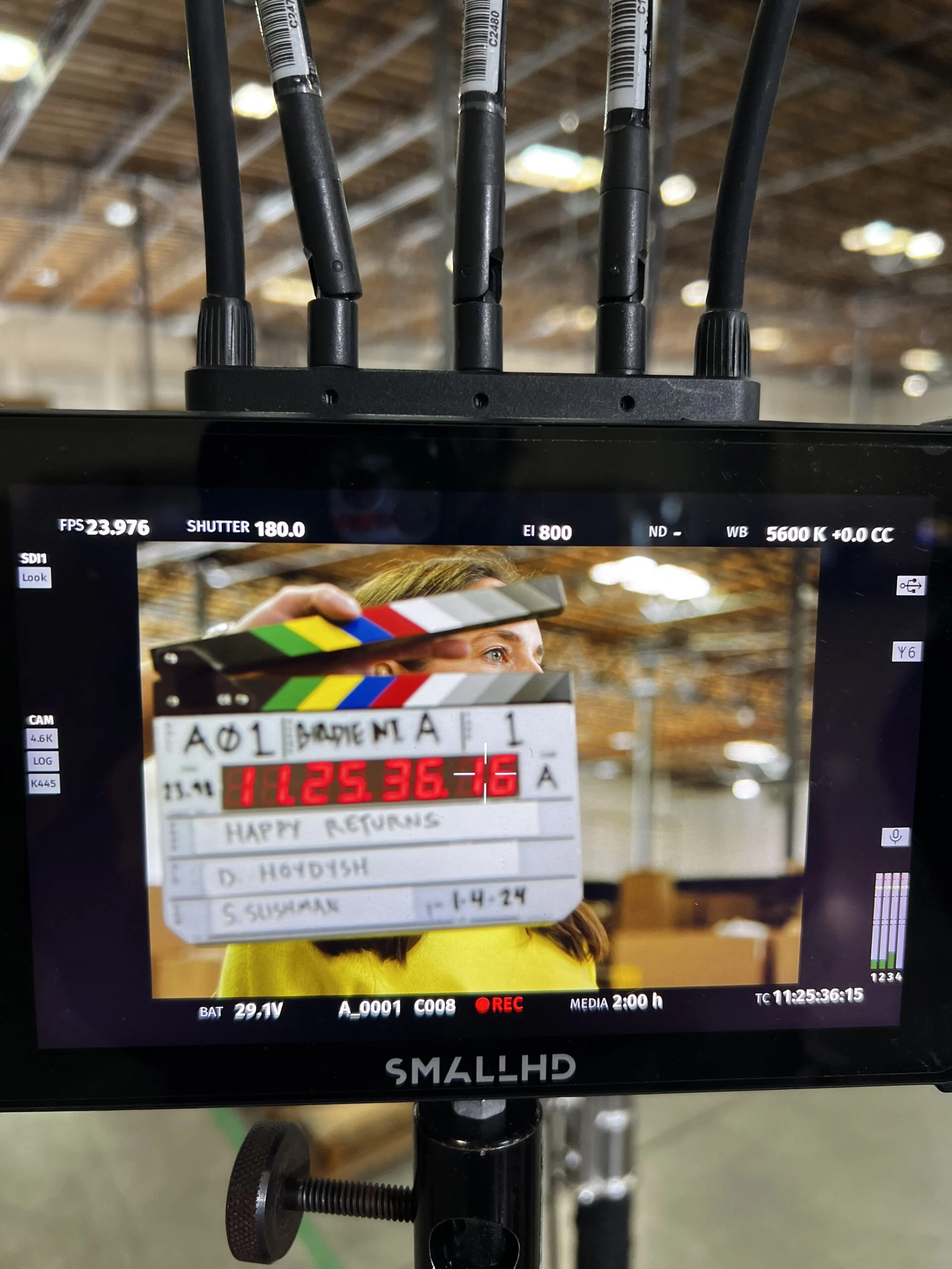 On-set monitor showing the slate for a Happy Returns warehouse shoot